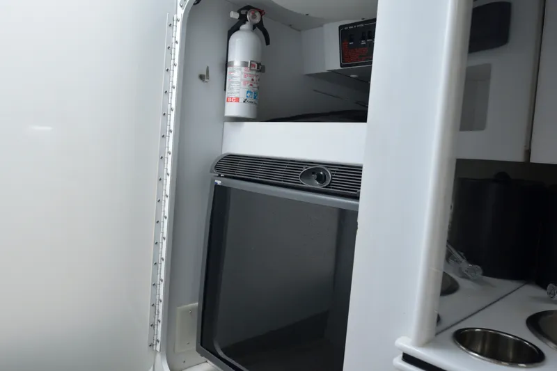 Slide: The Image of Interior of a 2006 Formula 353 FASTech boat with a fire extinguisher and kitchenette. - 22