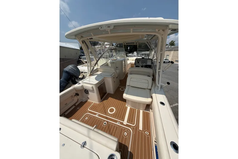 Slide: The Image of 2024 Grady-White Freedom 285 boat interior with seating and wood-patterned flooring. - 12