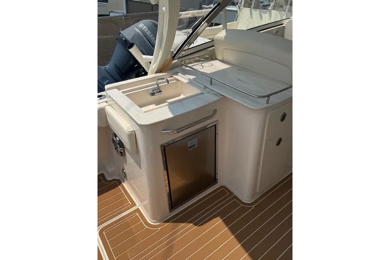 Slide: The Image of 2024 Grady-White Freedom 285 boat interior with sink and storage area. - 14