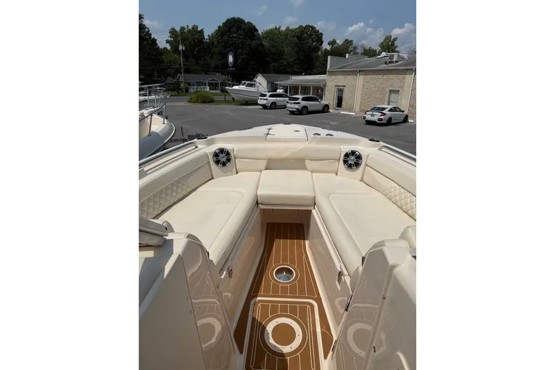 Slide: The Image of 2024 Grady-White Freedom 285 boat interior with cushioned seating and teak flooring. - 21