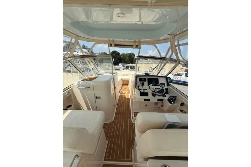 Slide: The Image of 2024 Grady-White Freedom 285 boat interior with helm and seating area. - 13