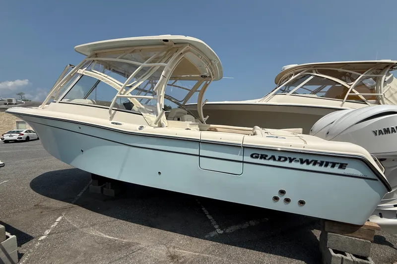 Slide: The Image of 2024 Grady-White Freedom 285 boat displayed outdoors on a sunny day. - 5