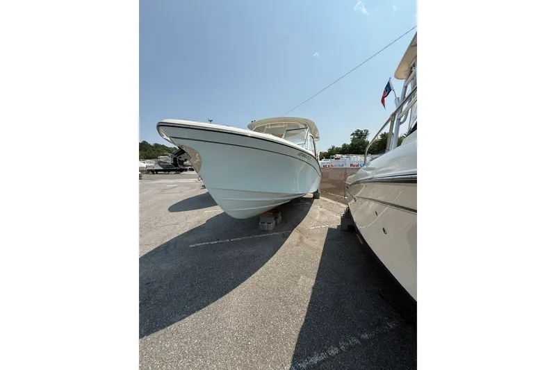 Slide: The Image of 2024 Grady-White Freedom 285 boat displayed outdoors on a sunny day. - 7