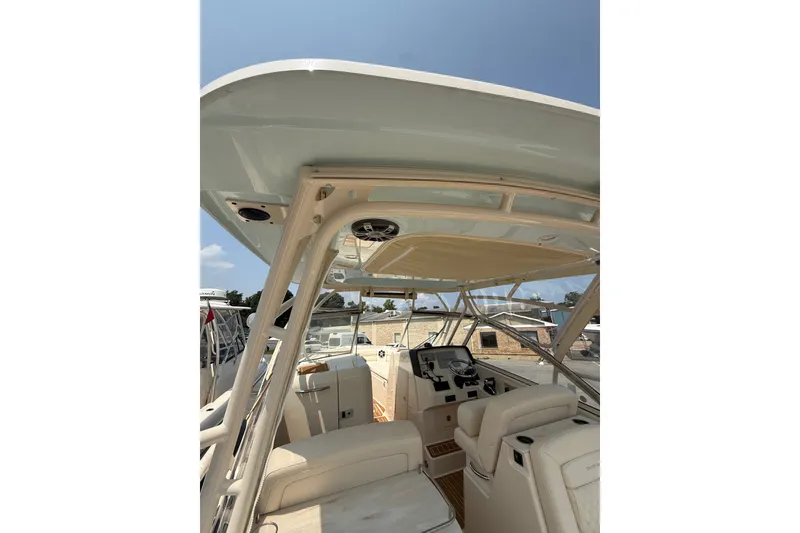Slide: The Image of 2024 Grady-White Freedom 285 boat interior with helm and seating area. - 2