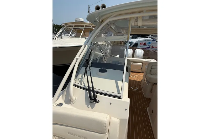 Slide: The Image of 2024 Grady-White Freedom 285 boat interior with seating and helm, showcasing luxury design. - 18