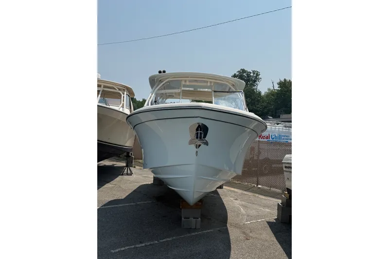 Slide: The Image of 2024 Grady-White Freedom 285 boat displayed outdoors, front view. - 8