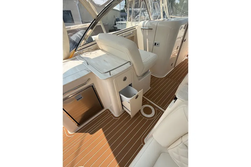 The Image of 2024 Grady-White Freedom 285 boat interior with sleek seating and wood-patterned flooring. - 1
