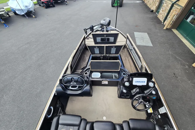 Slide: The Image of 2016 Nitro Z21 boat interior with steering wheel, seats, and storage compartments. - 2