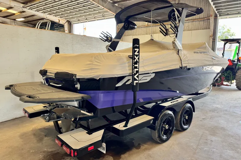 Slide: The Image of 2018 MB F24 Tomcat boat with cover on trailer in a garage. - 19