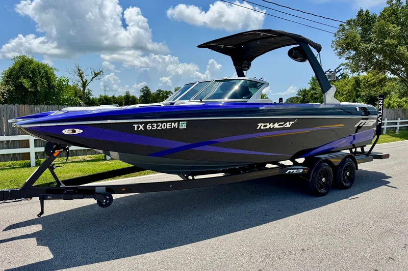 The Image of 2018 MB F24 Tomcat boat on trailer, parked on a sunny street. - 1
