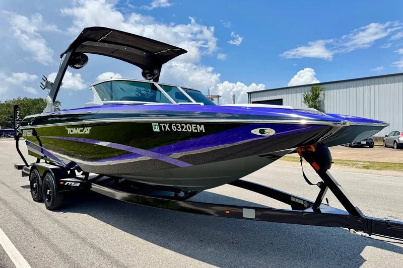 Slide: The Image of 2018 MB F24 Tomcat boat on trailer, sleek design, vibrant colors, sunny day. - 5