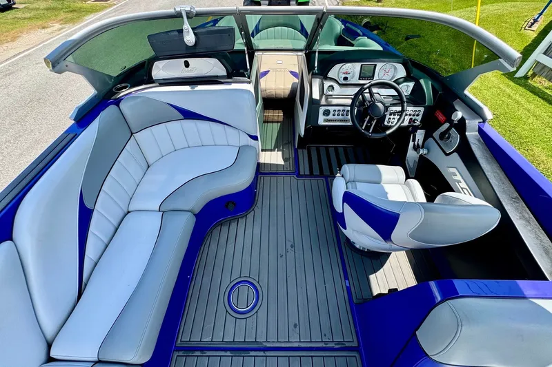 Slide: The Image of Interior of a 2018 MB F24 Tomcat boat with sleek seating and modern dashboard. - 14