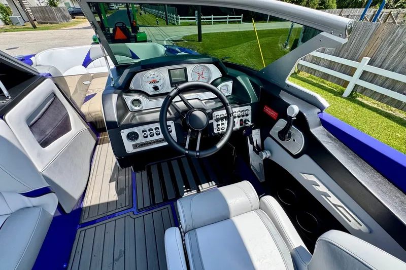 Slide: The Image of Interior of 2018 MB F24 Tomcat boat with steering wheel and dashboard controls. - 12