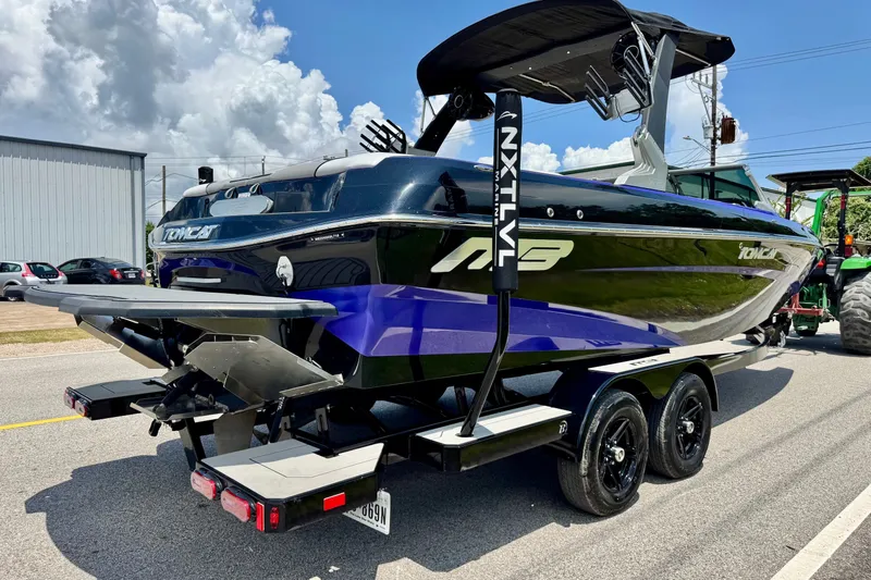 Slide: The Image of 2018 MB F24 Tomcat boat on trailer, featuring sleek design and vibrant colors. - 4