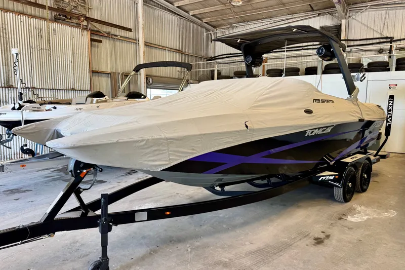 Slide: The Image of 2018 MB F24 Tomcat boat covered in storage, featuring sleek design and trailer. - 18
