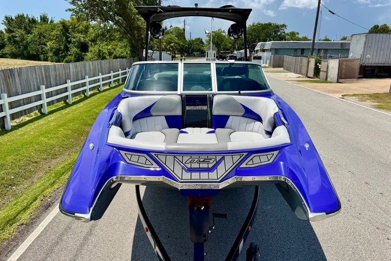 Slide: The Image of 2018 MB F24 Tomcat boat with blue exterior and spacious seating on a sunny day. - 6