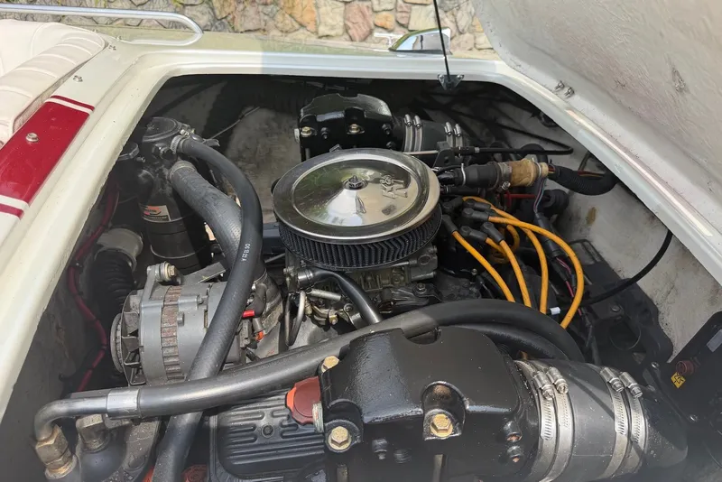 Slide: The Image of Engine compartment of a 1990 Donzi Sweet 16 boat, showcasing mechanical components. - 17
