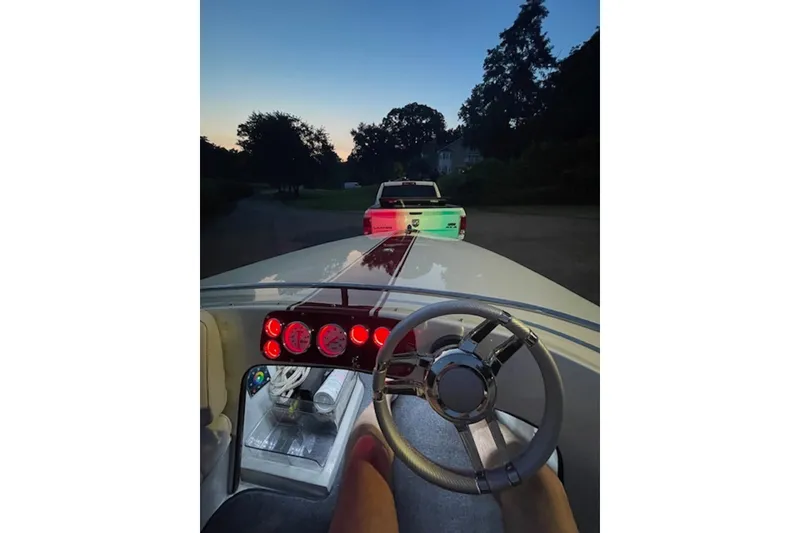 Slide: The Image of 1990 Donzi Sweet 16 boat interior with illuminated dashboard at dusk. - 8