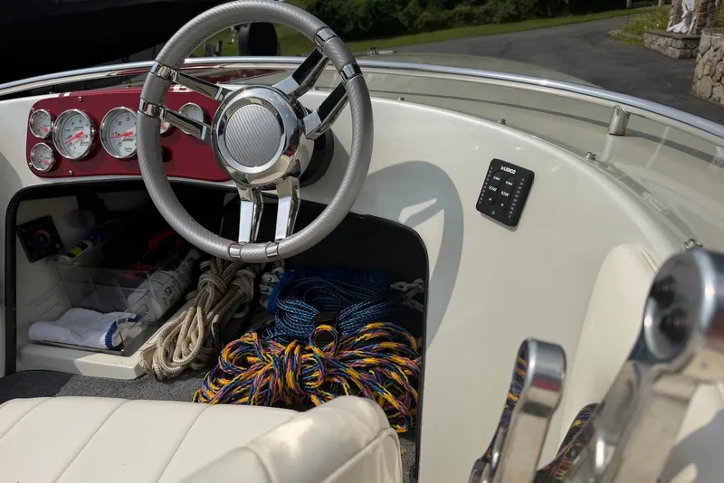 Slide: The Image of Interior of a 1990 Donzi Sweet 16 boat with steering wheel and ropes. - 6