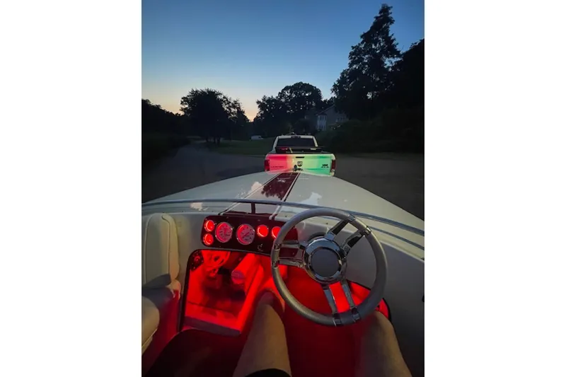 Slide: The Image of 1990 Donzi Sweet 16 boat interior with illuminated dashboard at dusk. - 9