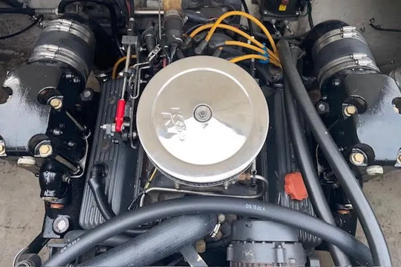 Slide: The Image of Engine of a 1990 Donzi Sweet 16 boat, showcasing detailed components and wiring. - 16