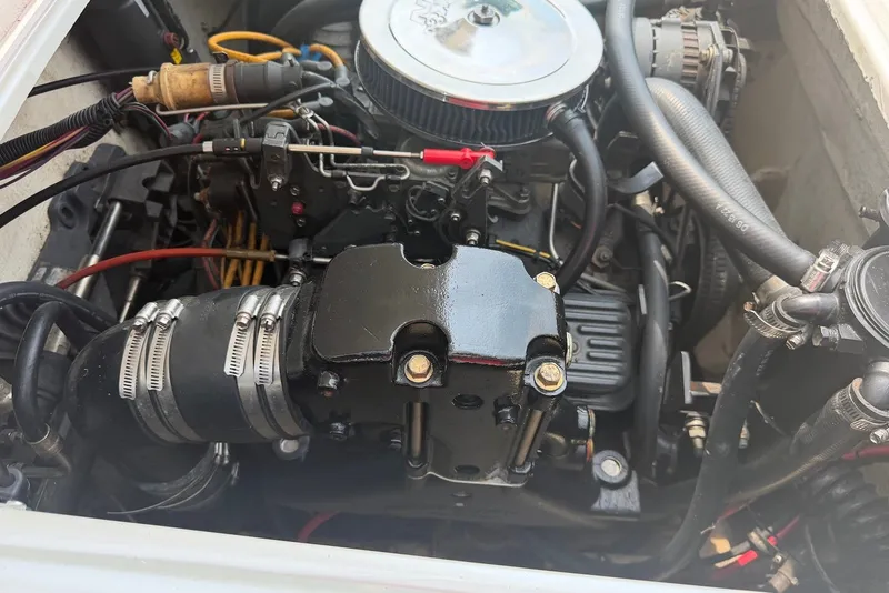 Slide: The Image of Engine of a 1990 Donzi Sweet 16 boat, showcasing detailed components and hoses. - 15