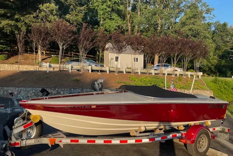Slide: The Image of 1990 Donzi Sweet 16 boat on trailer, red and white, parked outdoors. - 14