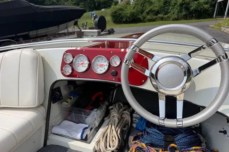 Slide: The Image of Interior of a 1990 Donzi Sweet 16 boat with steering wheel and gauges. - 5