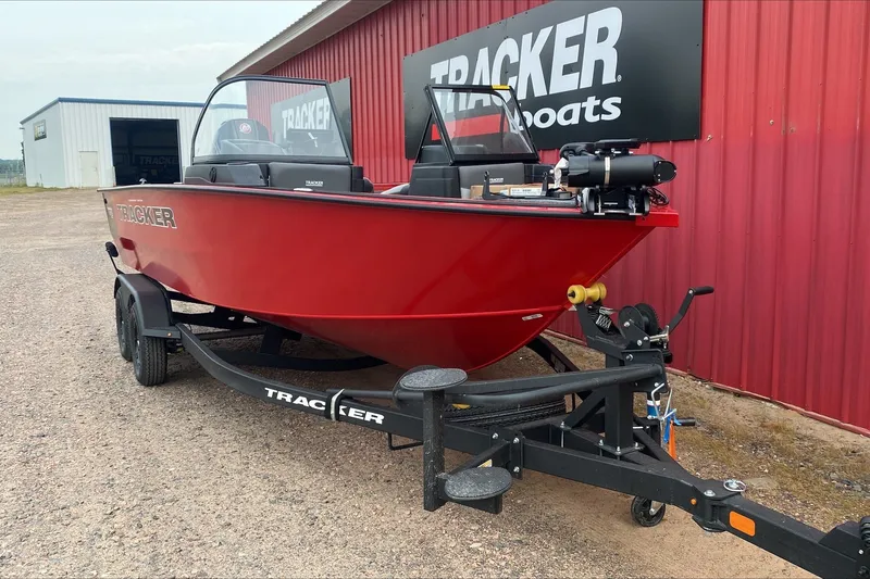 The Image of 2027 Tracker Targa V-18 WT boat in vibrant red on a trailer, parked outside. - 1