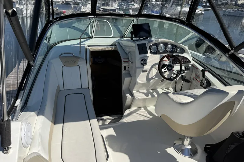 Slide: The Image of Interior view of a 2009 Sea Ray 230 Sundancer boat, featuring helm and seating area. - 4