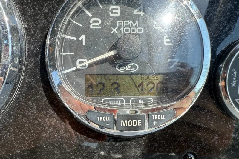 Slide: The Image of Close-up of a 2009 Sea Ray 230 Sundancer tachometer displaying RPM and voltage. - 12