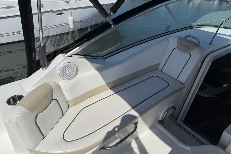 Slide: The Image of Interior view of a 2009 Sea Ray 230 Sundancer boat with white seating and speaker. - 5