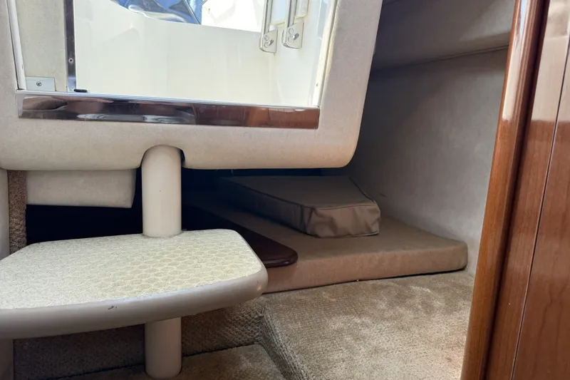 Slide: The Image of Interior cabin view of a 2009 Sea Ray 230 Sundancer boat, featuring carpeted steps and cozy sleeping area. - 10