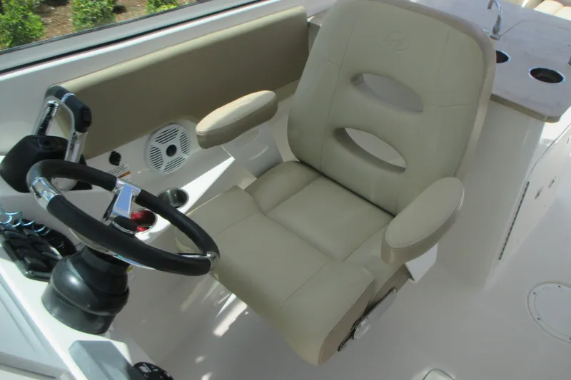 Slide: The Image of Captain's chair and steering wheel on a 2017 Sailfish 275 DC boat. - 23