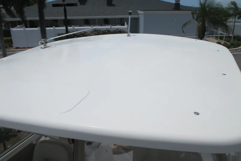 Slide: The Image of 2017 Sailfish 275 DC boat roof with clear sky and palm trees in background. - 32