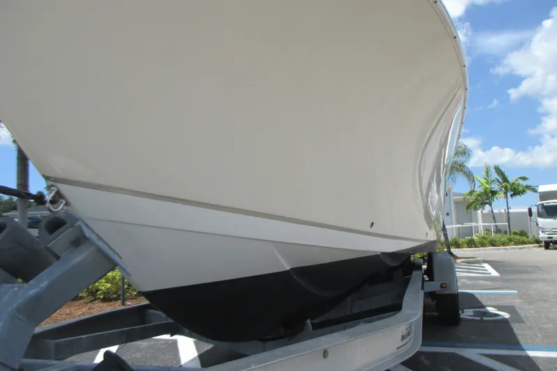 Slide: The Image of 2017 Sailfish 275 DC boat on trailer, viewed from below, with clear blue sky. - 4