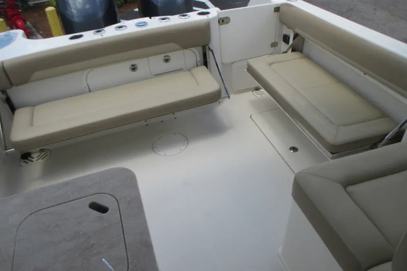 Slide: The Image of 2017 Sailfish 275 DC boat interior with beige seating and spacious layout. - 16