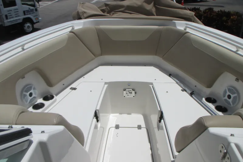 Slide: The Image of 2017 Sailfish 275 DC boat interior with beige seating and cup holders. - 33