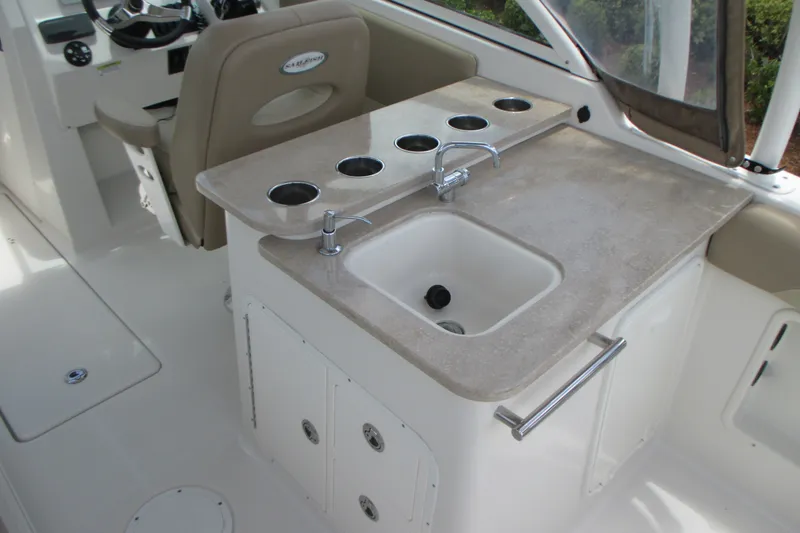 Slide: The Image of 2017 Sailfish 275 DC boat interior with sink and cup holders. - 18