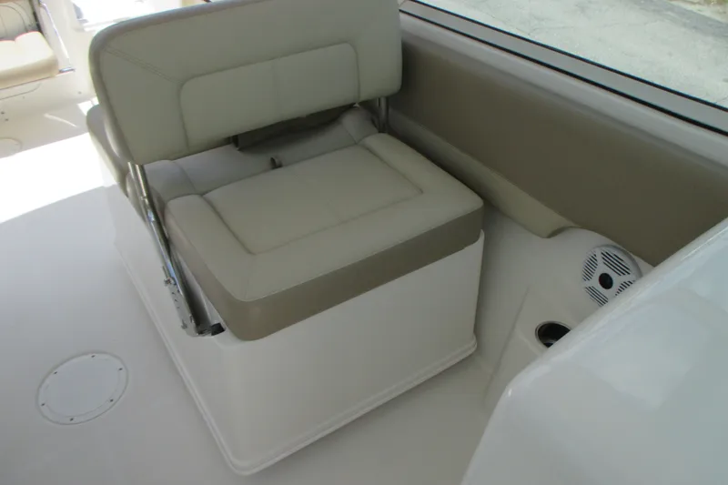 Slide: The Image of 2017 Sailfish 275 DC boat interior with beige cushioned seating and speaker. - 24