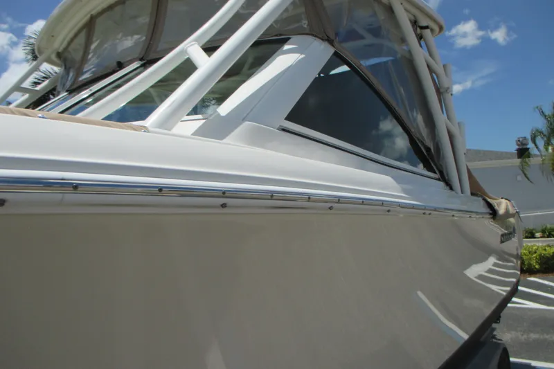 Slide: The Image of 2017 Sailfish 275 DC boat exterior with sleek design and clear blue sky background. - 6