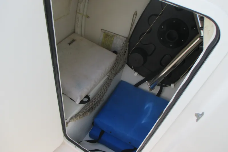 Slide: The Image of Storage compartment inside a 2017 Sailfish 275 DC boat, featuring cushions and equipment. - 26