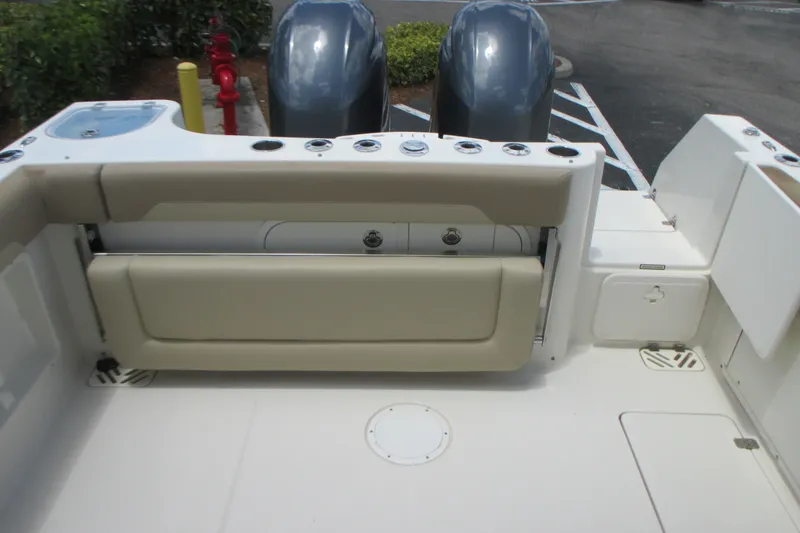 Slide: The Image of 2017 Sailfish 275 DC boat interior with seating and dual outboard motors. - 15