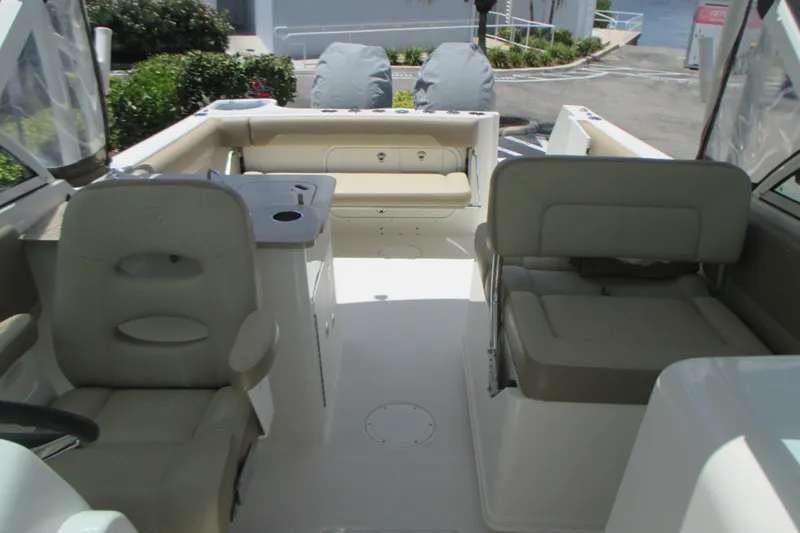 Slide: The Image of 2017 Sailfish 275 DC boat interior with seating and helm, showcasing spacious design. - 25