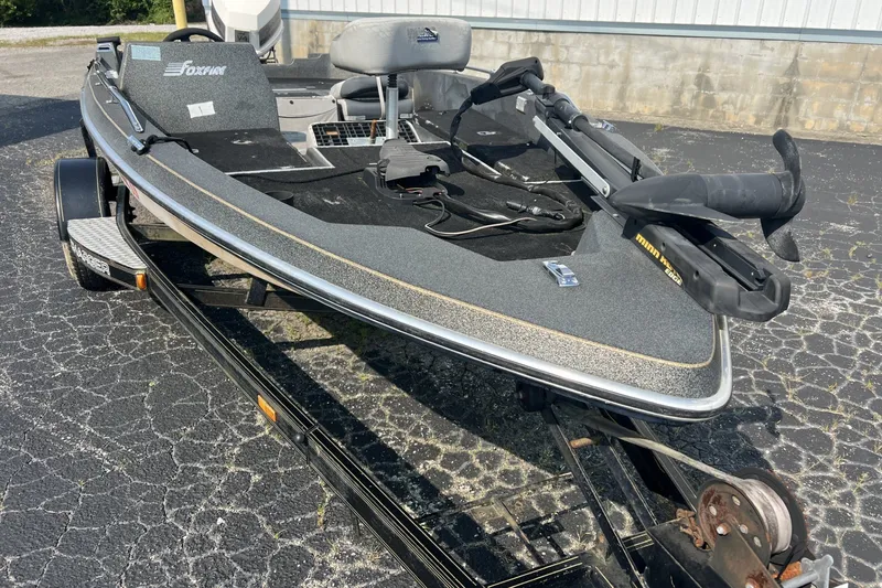 Slide: The Image of 1988 Charger 162V boat on trailer, featuring a Minn Kota trolling motor. - 4