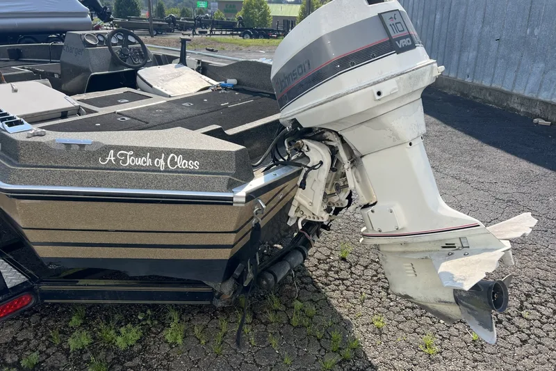 Slide: The Image of 1988 Charger 162V boat with Johnson outboard motor, labeled "A Touch of Class." - 6