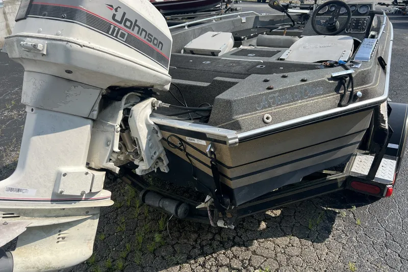 Slide: The Image of 1988 Charger 162V boat with Johnson 110 outboard motor on trailer. - 8