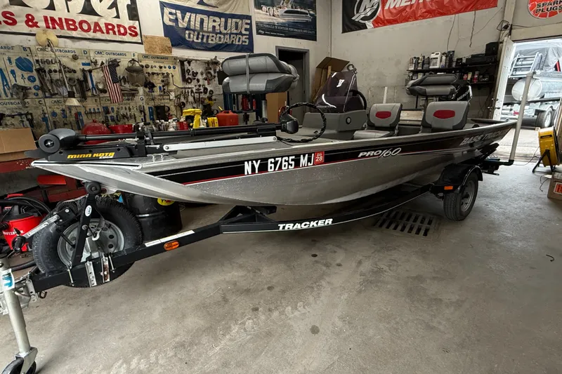 The Image of 2013 Bass Tracker Pro 16 fishing boat in a workshop setting. - 0
