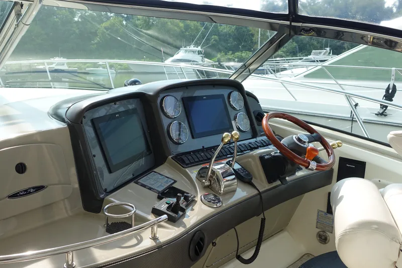 Slide: The Image of Helm of 2006 Sea Ray 44 Sundancer yacht with modern controls and navigation screens. - 7
