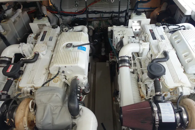 Slide: The Image of Engine room of a 2006 Sea Ray 44 Sundancer with dual engines and mechanical components. - 48